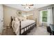 Bedroom featuring a queen-sized bed, large window, and natural light creating a warm and inviting space at 1975 Fairway Close Ter, Lawrenceville, GA 30043
