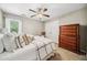 This bedroom has a ceiling fan, large closet, dresser and natural light creating a warm and inviting space at 1975 Fairway Close Ter, Lawrenceville, GA 30043