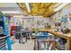 Unfinished garage with exposed ceiling, multiple work benches and access to tools at 1975 Fairway Close Ter, Lawrenceville, GA 30043