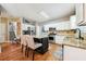 A gourmet kitchen featuring a center island with seating, stainless steel appliances, and white cabinets at 1975 Fairway Close Ter, Lawrenceville, GA 30043