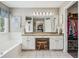 Bright, updated main bathroom featuring double sinks, vanity area, and separate walk-in closet for ample storage at 1975 Fairway Close Ter, Lawrenceville, GA 30043