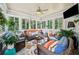 Bright sunroom with large windows, comfortable seating, and a ceiling fan at 1975 Fairway Close Ter, Lawrenceville, GA 30043