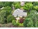 Aerial view of the house with manicured landscaping, mature trees, and a beautiful stone patio at 2117 Stephens Walk, Dunwoody, GA 30338