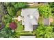 Aerial view of the house with well-maintained landscaping and a stone patio surrounded by lush greenery at 2117 Stephens Walk, Dunwoody, GA 30338