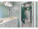 Bright bathroom with vertical striped wallpaper, white cabinets, and framed mirror at 2117 Stephens Walk, Dunwoody, GA 30338