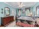 Bedroom with blue walls features wood floors, four poster bed, and a ceiling fan at 2117 Stephens Walk, Dunwoody, GA 30338