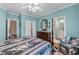 Bedroom featuring crown molding, blue walls, wood floors, and a four-poster bed at 2117 Stephens Walk, Dunwoody, GA 30338