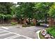Entrance to the community featuring landscaped flower beds, trees, and a brick entrance at 2117 Stephens Walk, Dunwoody, GA 30338