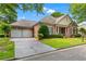 Elegant brick home boasts an attached two-car garage and a beautifully landscaped front yard at 2117 Stephens Walk, Dunwoody, GA 30338