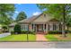 Charming brick home featuring a manicured front yard and inviting covered porch with stately columns at 2117 Stephens Walk, Dunwoody, GA 30338