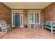 Spacious brick front porch featuring comfortable seating and classic architectural details at 2117 Stephens Walk, Dunwoody, GA 30338
