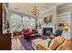 Cozy living room with a fireplace, large windows, and comfortable seating at 2117 Stephens Walk, Dunwoody, GA 30338