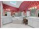 Bright primary bathroom with a vaulted ceiling, skylight, tub, and dual vanities at 2117 Stephens Walk, Dunwoody, GA 30338