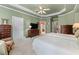 Spacious bedroom featuring carpet floors, tray ceilings, and classic wood furniture at 2117 Stephens Walk, Dunwoody, GA 30338