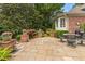 Beautifully landscaped backyard featuring a stone patio with outdoor seating and manicured plants at 2117 Stephens Walk, Dunwoody, GA 30338