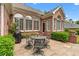 Charming brick home with a stone patio and outdoor seating area, perfect for entertaining at 2117 Stephens Walk, Dunwoody, GA 30338