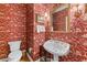 Charming powder room with unique wallpaper, pedestal sink, and decorative mirror at 2117 Stephens Walk, Dunwoody, GA 30338