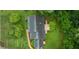 Aerial view of a home with dark roof, brick pathway, a deck, and surrounded by lush green trees and grass at 380 Lamplighter Se Ln, Marietta, GA 30067
