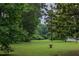 Large, well-maintained lawn with mature trees and seating, offering a peaceful retreat in a natural setting at 380 Lamplighter Se Ln, Marietta, GA 30067