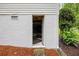 Basement entry from an exterior door is surrounded by mature vegetation at 380 Lamplighter Se Ln, Marietta, GA 30067