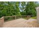 The home features a deck with railing and a view of mature trees at 380 Lamplighter Se Ln, Marietta, GA 30067