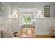 Hallway view into a breakfast nook, with hardwood floors, white wainscoting and walls, and stylish sconces at 380 Lamplighter Se Ln, Marietta, GA 30067