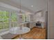 White kitchen with stainless appliances, large windows, wood floors and a breakfast nook at 380 Lamplighter Se Ln, Marietta, GA 30067