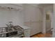 White kitchen cabinets with stainless steel gas range and ovens at 380 Lamplighter Se Ln, Marietta, GA 30067