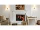 Living room featuring a traditional white brick fireplace with mantel and decorative sconces at 380 Lamplighter Se Ln, Marietta, GA 30067