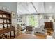 Bright living area features a plank ceiling, built-in shelves, and a large window overlooking the backyard at 380 Lamplighter Se Ln, Marietta, GA 30067