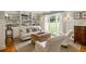 Bright living room featuring built-in bookshelves, large window, hardwood floors, and comfortable seating at 380 Lamplighter Se Ln, Marietta, GA 30067