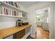 Butler's pantry featuring open shelving, wooden countertop, and views into the bright white kitchen at 380 Lamplighter Se Ln, Marietta, GA 30067