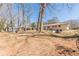 Large, grassy backyard and exterior of home with a walk-out basement entrance at 442 Mountain Park Trl, Stone Mountain, GA 30087