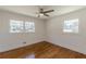 Bedroom with hardwood floors, ceiling fan, and windows at 442 Mountain Park Trl, Stone Mountain, GA 30087