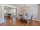 Elegant dining area featuring hardwood floors, a chandelier, and an open view to the modern kitchen at 442 Mountain Park Trl, Stone Mountain, GA 30087