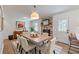 Dining room with a modern light fixture, dining table, and a view into the kitchen at 442 Mountain Park Trl, Stone Mountain, GA 30087