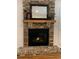 Close-up of a traditional brick fireplace with a wooden mantel and decorative accents, creating a cozy focal point at 442 Mountain Park Trl, Stone Mountain, GA 30087