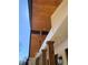 Low angle image of stained wood porch ceiling and craftsman columns with outdoor lighting fixture at 442 Mountain Park Trl, Stone Mountain, GA 30087