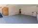 Attached garage featuring painted brick and wooden slats over an epoxy floor at 442 Mountain Park Trl, Stone Mountain, GA 30087