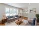 Inviting living room with large windows, a comfortable sofa, and natural light at 442 Mountain Park Trl, Stone Mountain, GA 30087