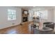 Open living space featuring a cozy brick fireplace, hardwood floors, and a seamless flow to the kitchen at 442 Mountain Park Trl, Stone Mountain, GA 30087