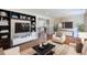 Bright living room featuring built-in shelves, a modern entertainment center, and stylish furnishings at 442 Mountain Park Trl, Stone Mountain, GA 30087
