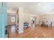 Bright, open-concept living room with hardwood floors and modern decor, seamlessly flowing into the dining area at 442 Mountain Park Trl, Stone Mountain, GA 30087