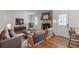 Virtually staged living room with brick fireplace, hardwood floors, and natural light at 442 Mountain Park Trl, Stone Mountain, GA 30087