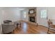 Comfortable living area with a brick fireplace, hardwood floors, and stylish seating, adjacent to the kitchen at 442 Mountain Park Trl, Stone Mountain, GA 30087