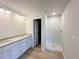 Bathroom features a dual sink vanity with granite counters and a tiled glass enclosed shower at 66 Pine Creek Ct, Dallas, GA 30157