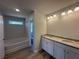Bathroom boasts a dual sink vanity with granite counters, a soaking tub, and a private water closet at 66 Pine Creek Ct, Dallas, GA 30157