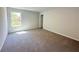 Bright carpeted bedroom features a neutral color palette and a window at 66 Pine Creek Ct, Dallas, GA 30157