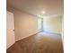 Cozy carpeted bedroom features a neutral color palette and natural light at 66 Pine Creek Ct, Dallas, GA 30157