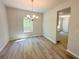 Bright dining room with hardwood floors, chandelier, and natural light from the window at 66 Pine Creek Ct, Dallas, GA 30157
